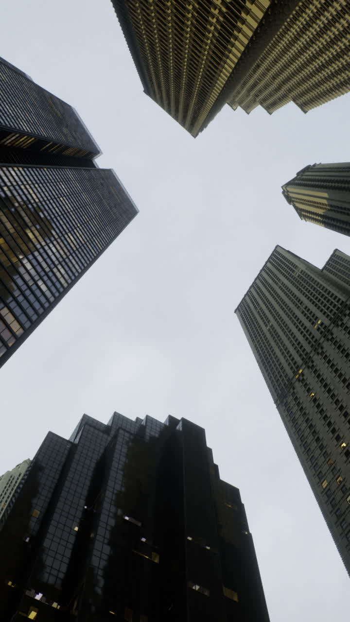 Skyscrapers rise to meet the cloudy sky in a vibrant metropolis at dusk