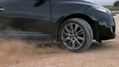 slow motion of a car wheel drifting on a dirty road