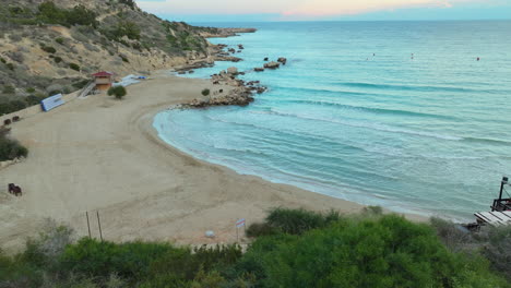 twilight at konnos beach, ayia napa, cyprus, with sandy shore and clear waters