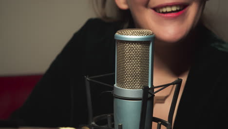 Close-up-of-the-presenter's-mouth-and-hands-in-front-of-the-microphone-using-large-gestures