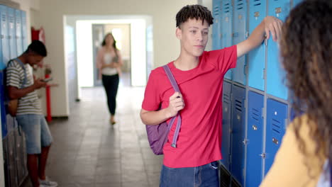 teenage biracial boys and girl in a high school hallway