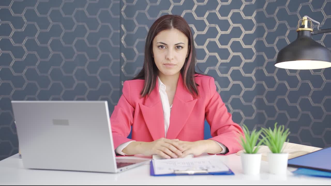 una joven mujer de negocios diciendo que no a la cámara.
