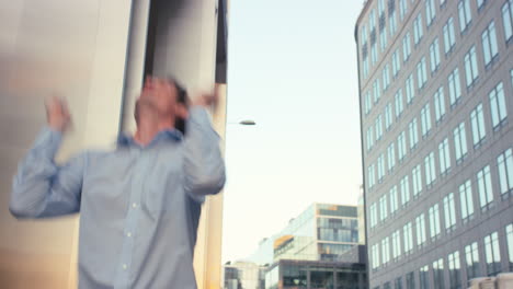 Contemporary-funky-caucasian-businessman-street-dancer-dancing-freestyle-in-the-city