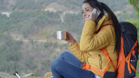 Happy-female-hiker-on-phone