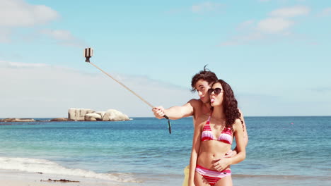 Happy-couple-doing-selfie-with-monopod