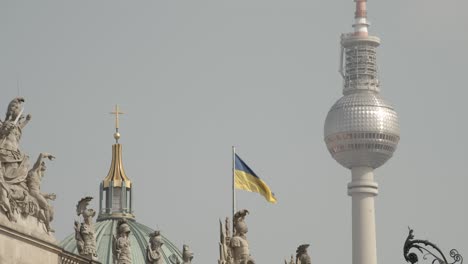 Flag-of-Ukraine-besides-the-Berliner-Fernsehturm-and-the-top-of-the-Berliner-Dom