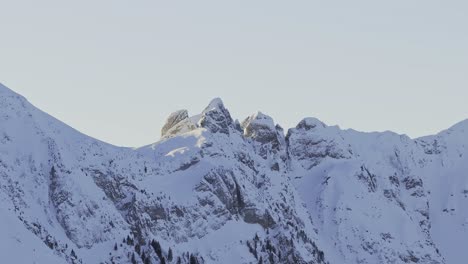 Dawn-aerial-perspective-revealing-the-silhouette-of-snow-capped-mountains