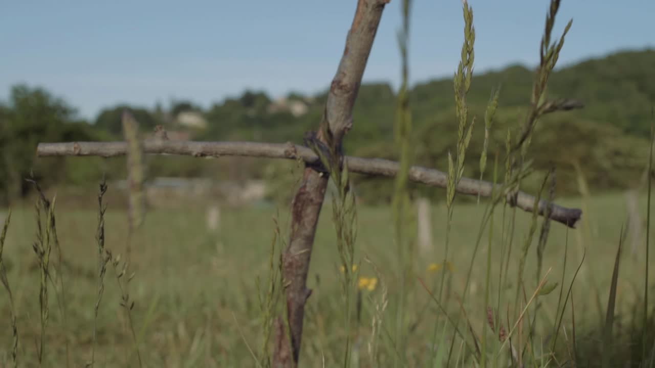 Handmade wooden cross in a field