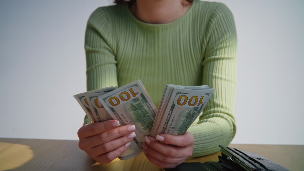Businesswoman hands holding money of 100 dollars closeup. Cashier counting cash