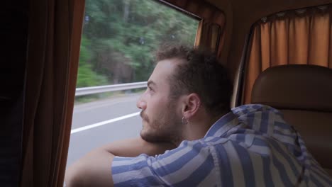 Traveling-adventurous-man-watching-out-the-window.