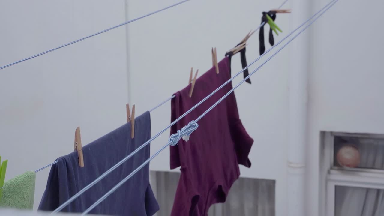 Steady view on laundry hanging on ropes being pulled forward