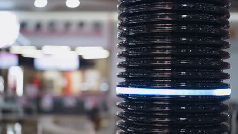 Black-pipe-with-glowing-led-ring-installed-in-shopping-mall