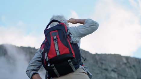 senior man shielding his eyes while standing at countryside 4k