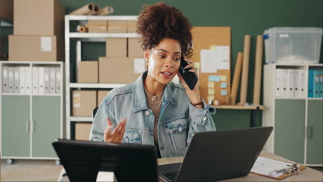 woman working at desk with laptop and phone