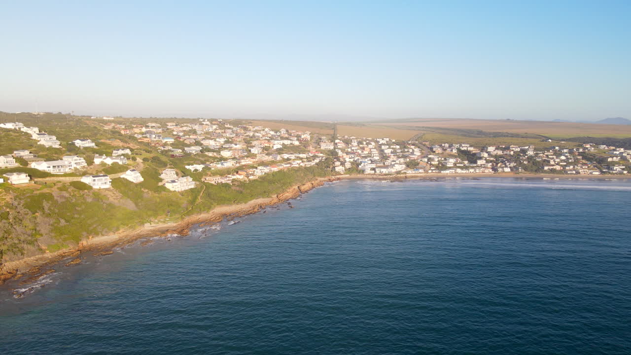 Sunrise drone view over Indian ocean of exclusive Vleesbaai on hillside