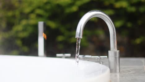 water consistently streaming from a tap outdoors