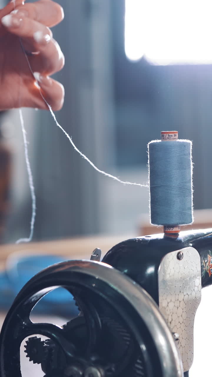 Old sewing machine. Close up of sewing machine and threads Vertical video