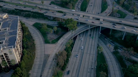 aerial view of a bustling highway interchange and city skyline