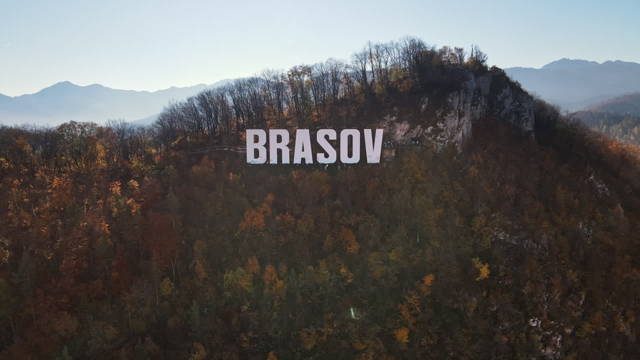 Brasov sign on the top of the hill near the city, yellowed trees, Romania