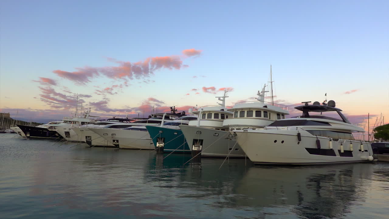 Antibes, France - July 2, 2025: Multiple white boats docked in the Port Vauban at sunset