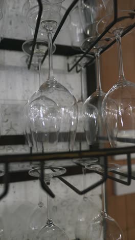 Hanging wine glasses on modern rack | Premium Photo