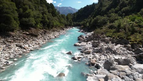 drone flyover beautiful and wild copland river surrounded by lush green forest, new zealand hike