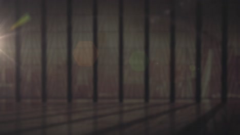 animation of window with bars with glowing spots of light  in the background