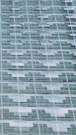 window structures of greenhouses with open transoms for ventilation. aerial view of the glass building. vertical video