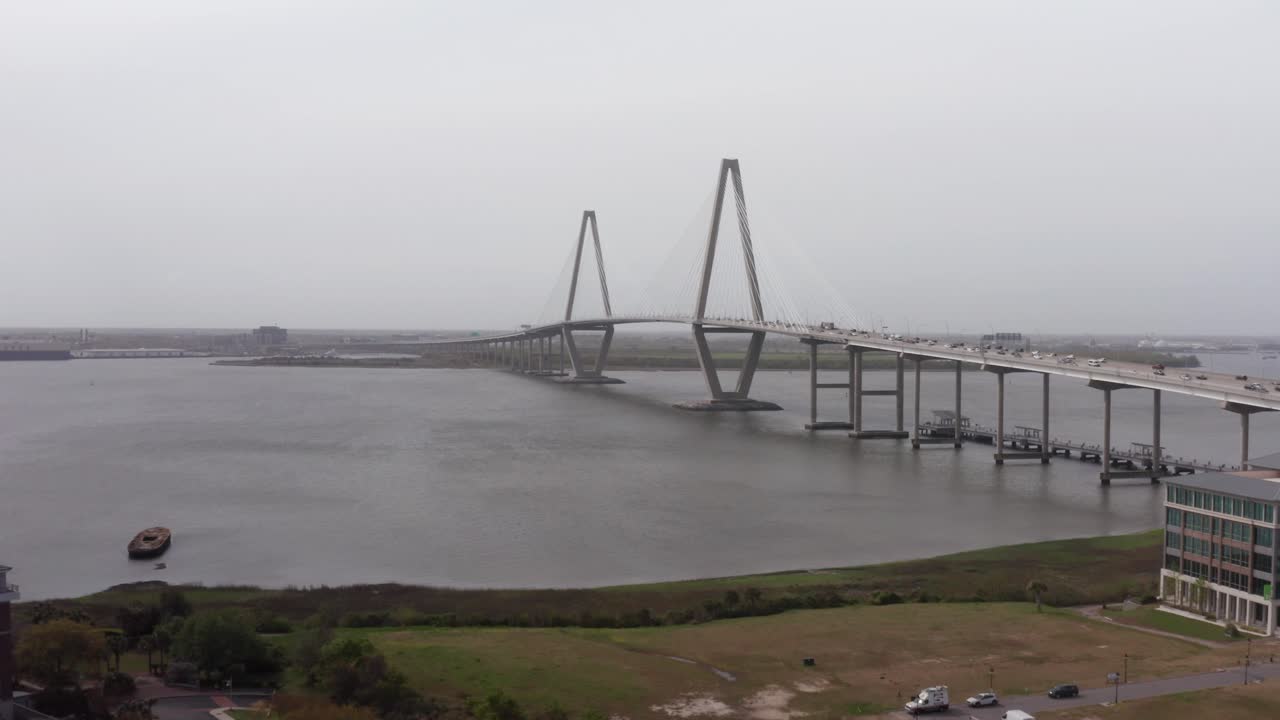 Wide rising aerial shot of Ravenel Bridge from Patriot's Point on a hazy day in Mount Pleasant, South Carolina. 4K