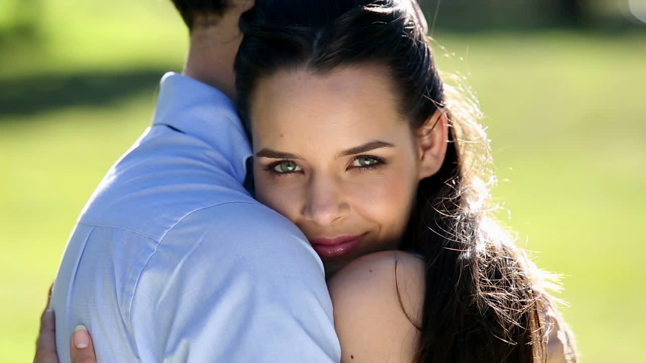 Happy couple embracing in the park