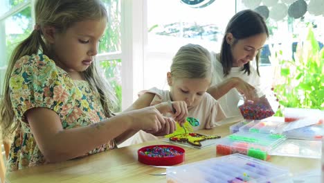 mother and daughters crafting together