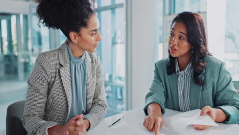 two businesswomen collaborating in an office