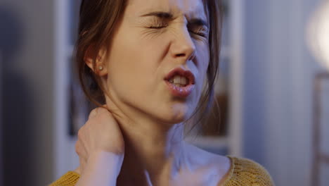 Close-Up-Of-The-Young-Woman-Holding-Her-Neck-Behind-As-She-Having-Headache-And-Feeling-Pain-In-The-Neck-And-Back