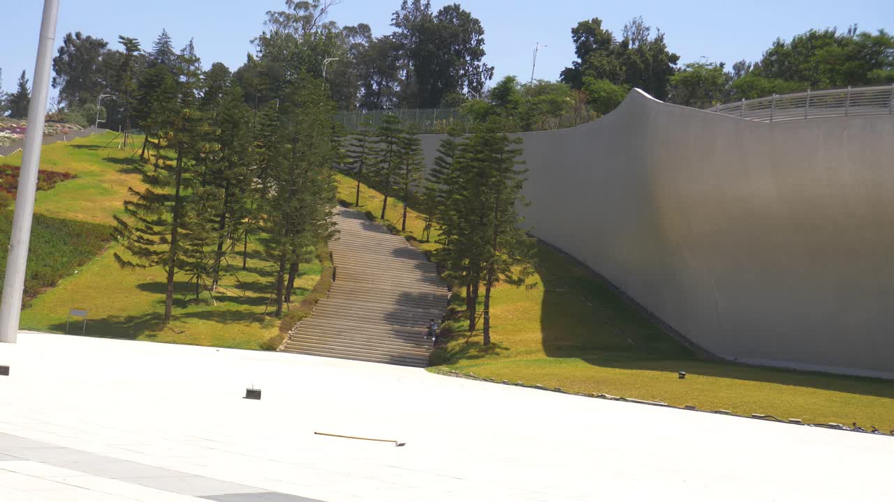long stairs on green hill in Friendship park with big paved area in front