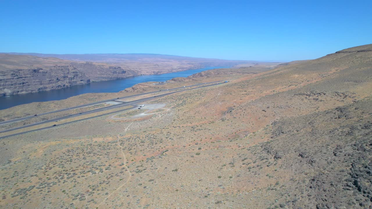 Aerial View of a Desert Canyon with a Highway and River