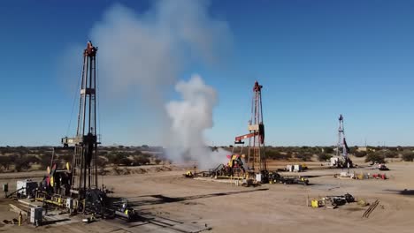 dramatic scenes of oil drilling operations in a desert landscape showcasing equipment and smoke emissions from the extraction process