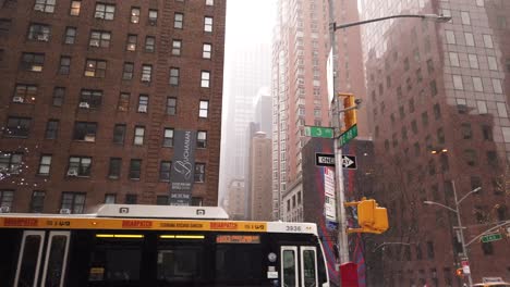 cinematic and slow motion shots filmed in new york city during a snowstorm. dynamic pedestrians and vehicles. forward reveal.
