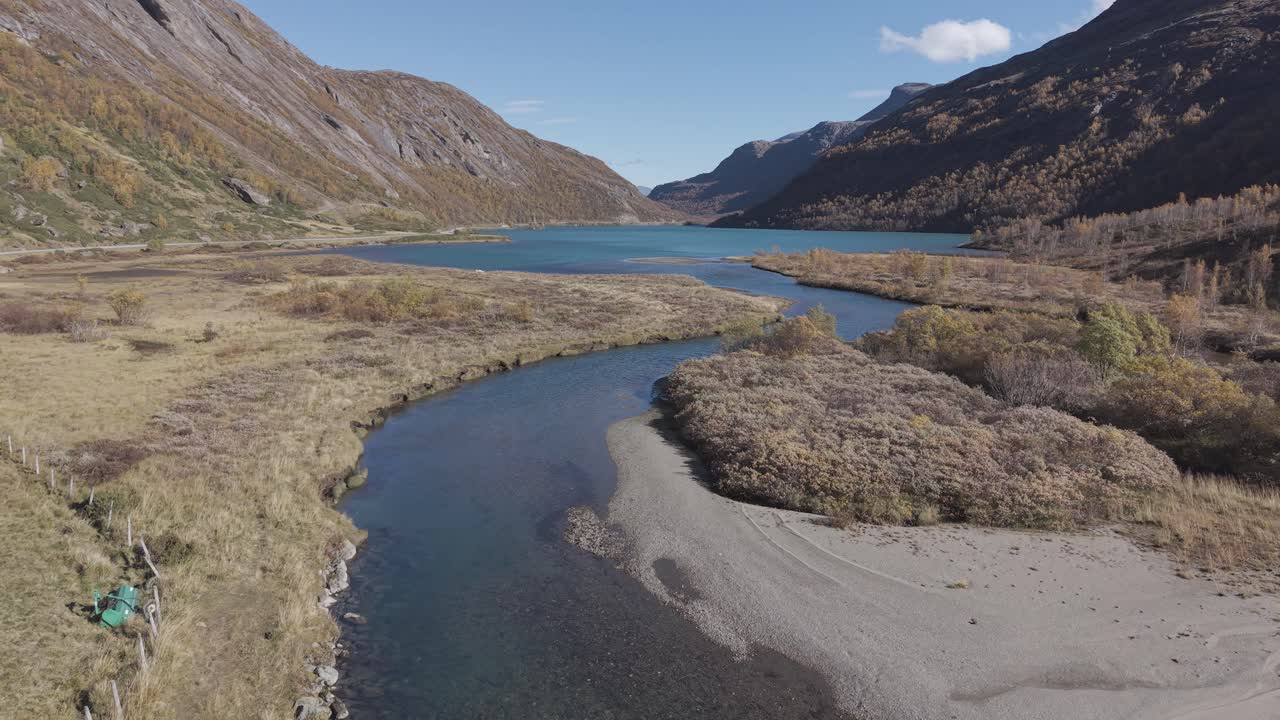 Flying towards glacier lake in Jotunheimen National Park in Norway. Drone footage in Autumn