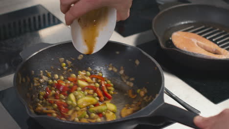 adding sauce to pan-fried vegetables