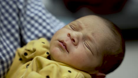 New-Born-Baby-Asleep-In-Parents-Arm