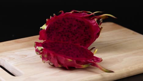 hand cuts and reveals vibrant dragon fruit