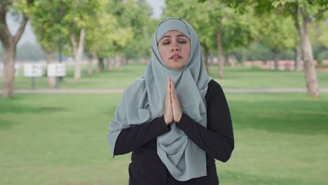 guilty muslim woman saying sorry and apologizing in park