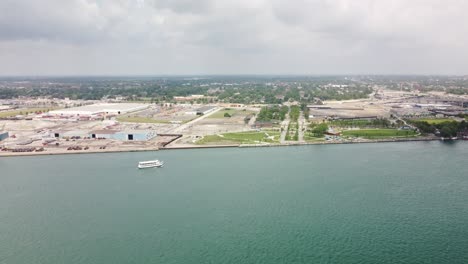 4k drone view of tour boat sailing on lake erie between windsor and detroit