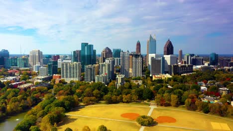 Aerial-drone-shot-of-midtown-Atlanta,-Georgia-slowly-flying-backwards-revealing-much-of-Piedmont-Park-and-its-amenities