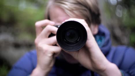 man handling camera in slow motion, slowly zooming out as the camera points into the frame