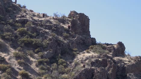 Pan-along-a-rocky-desert-mountain-ridge,-winter,-Scottsdale,-Arizona