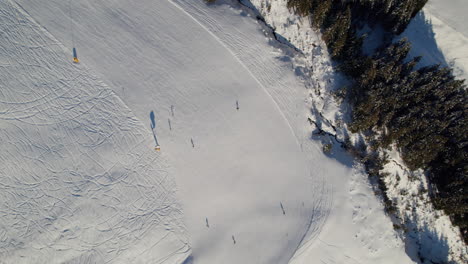 ski area with people skiing in saalbach-hinterglemm, austria - aerial top down