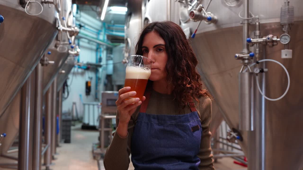Donna che assaggia birra in un birrificio
