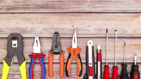 construction and work tools moving on the bottom of wooden table - do it your self stop motion