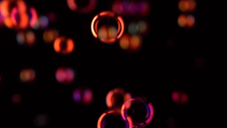 red soap bubbles fly in the air slow motion black background many red soap bubbles fly in the air slow motion black background